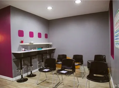 Salle de réunion moderne avec murs gris, barre haute, tabourets et chaises à Toulouse en Haute-Garonne 31